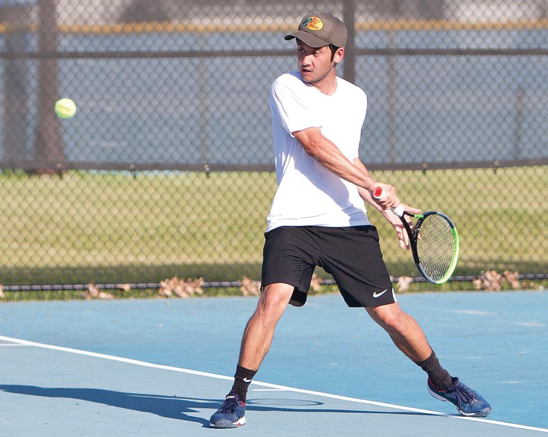 Former Crawfordsville tennis standout George Go returns a ball during the annual Strawberry Festival tennis tournament.